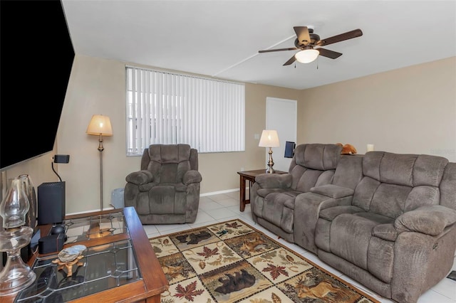 tiled living room featuring a ceiling fan and baseboards