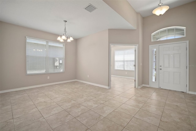 foyer featuring an inviting chandelier, light tile patterned floors, baseboards, and visible vents