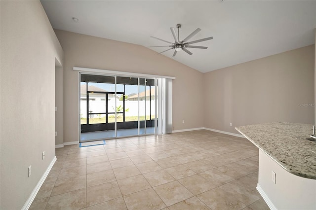 interior space with light tile patterned floors, baseboards, lofted ceiling, and a ceiling fan