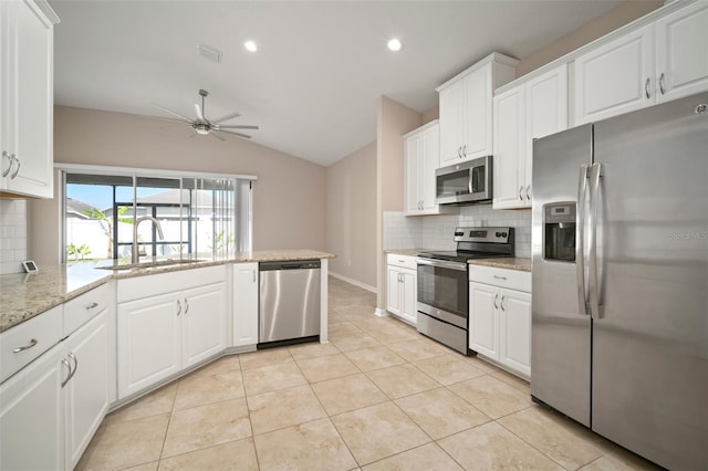 kitchen with white cabinets, light tile patterned floors, appliances with stainless steel finishes, and a sink