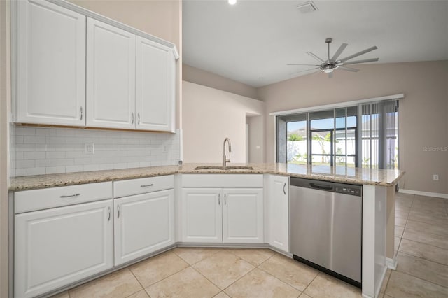 kitchen featuring a peninsula, light tile patterned flooring, a sink, dishwasher, and backsplash