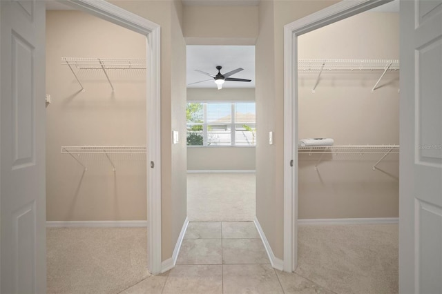 spacious closet featuring tile patterned floors, carpet floors, and ceiling fan