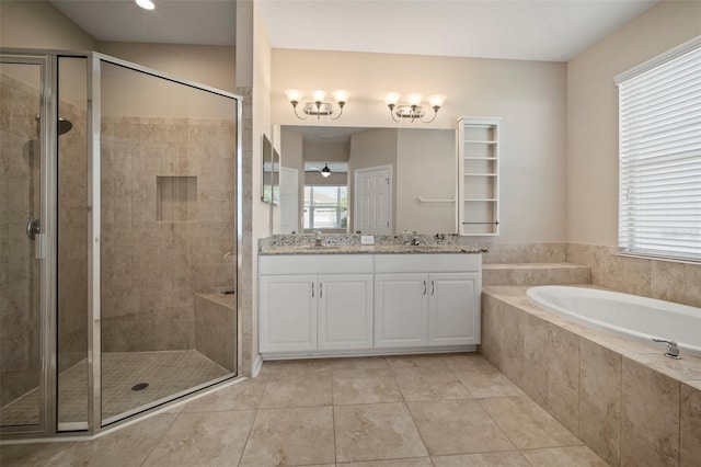 bathroom with a stall shower, a garden tub, and a sink