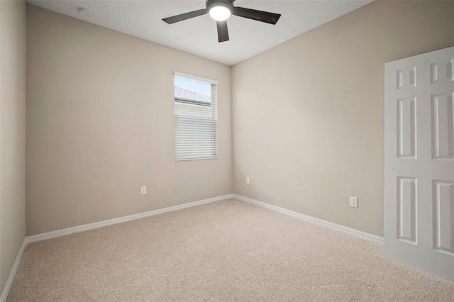 carpeted empty room with baseboards and ceiling fan