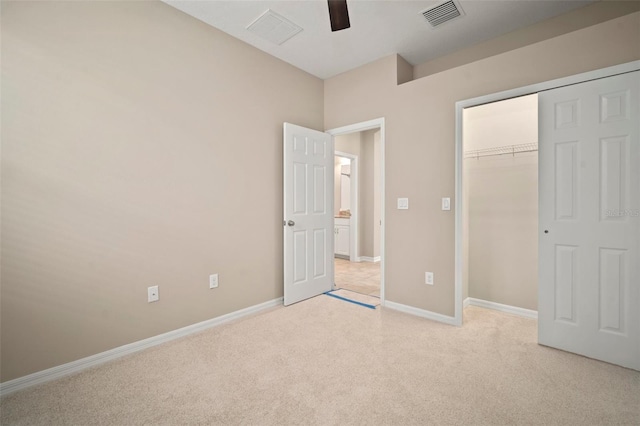 unfurnished bedroom featuring visible vents, light carpet, baseboards, and a closet