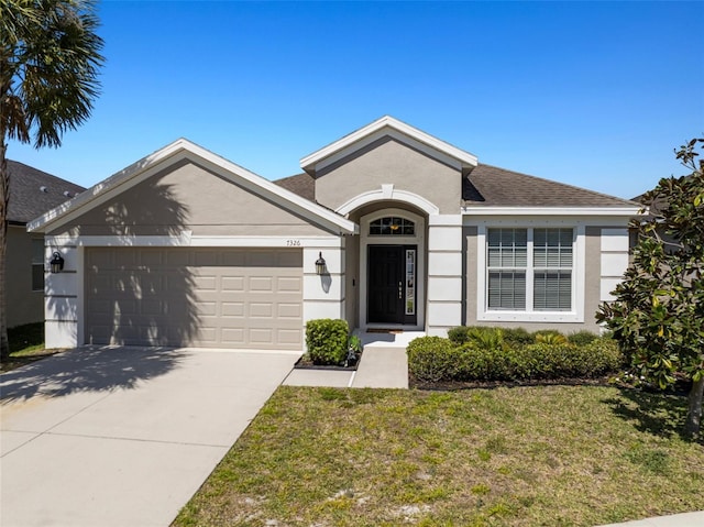 ranch-style home with stucco siding, roof with shingles, concrete driveway, a front yard, and an attached garage