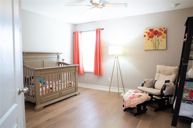 bedroom with wood finished floors, baseboards, and ceiling fan