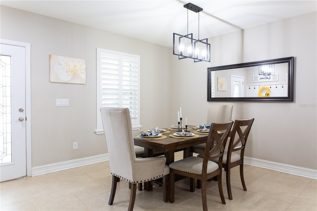 dining area with light tile patterned flooring, a healthy amount of sunlight, and baseboards