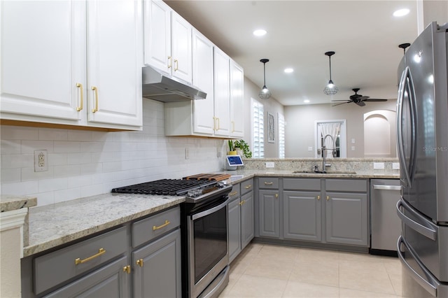 kitchen with gray cabinetry, a ceiling fan, under cabinet range hood, a sink, and appliances with stainless steel finishes