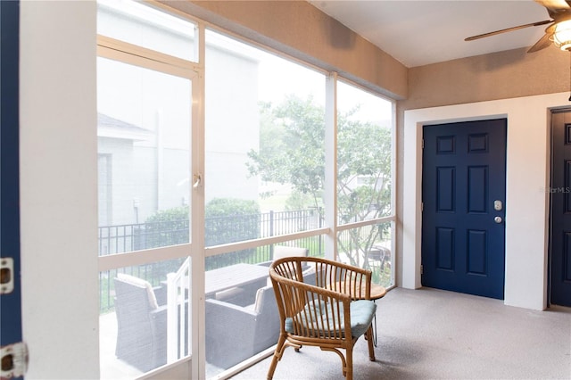 sunroom / solarium featuring plenty of natural light and a ceiling fan