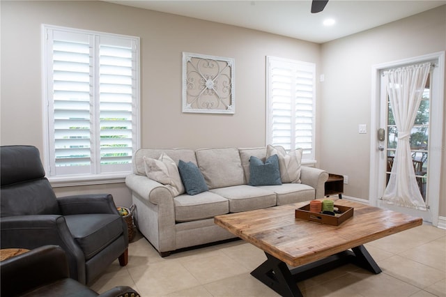 living area featuring recessed lighting, light tile patterned flooring, and a ceiling fan