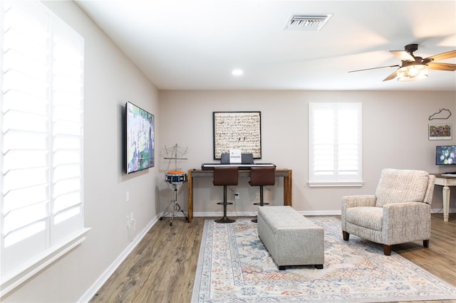 home office featuring a wealth of natural light, visible vents, and wood finished floors