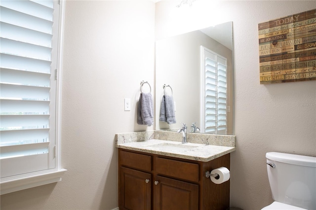 half bath with vanity and toilet