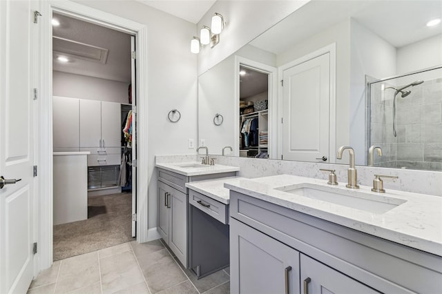 bathroom with vanity, a walk in closet, and a stall shower