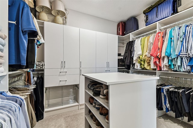 walk in closet featuring light colored carpet