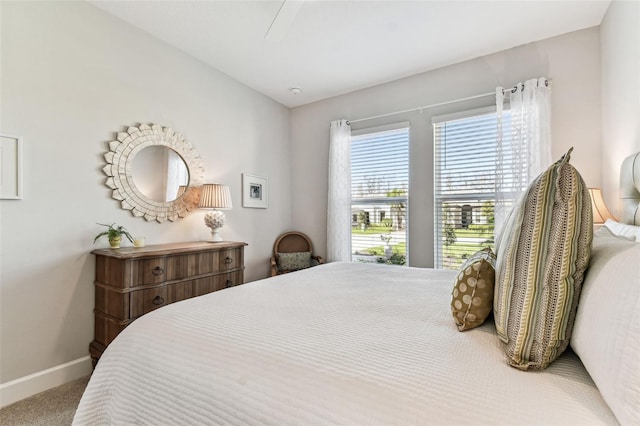 carpeted bedroom with baseboards