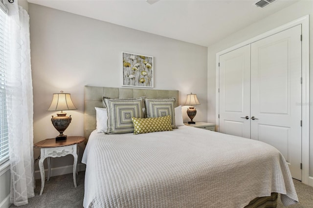 bedroom featuring visible vents, carpet, a closet, and baseboards