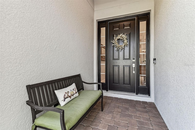 property entrance featuring stucco siding