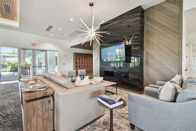 living area featuring recessed lighting, visible vents, and french doors