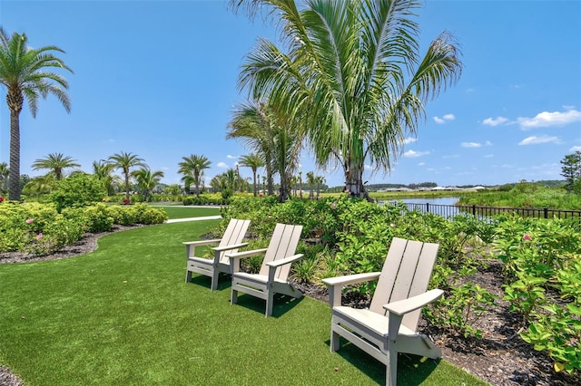 view of yard featuring fence and a water view