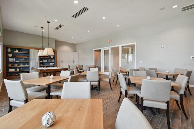 dining room with visible vents, recessed lighting, and wood tiled floor