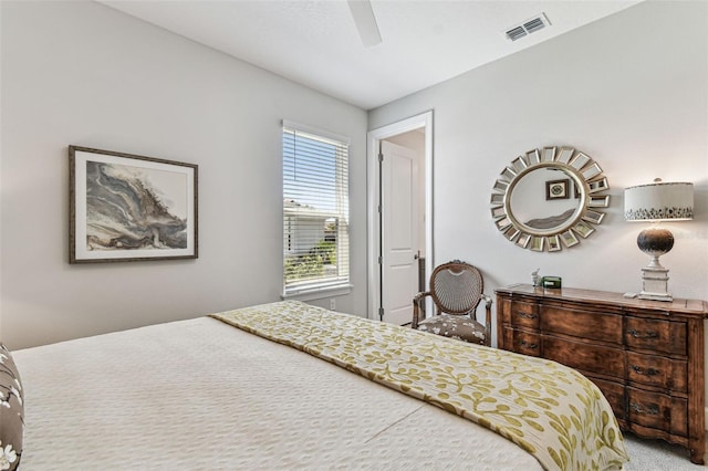 carpeted bedroom featuring visible vents and a ceiling fan