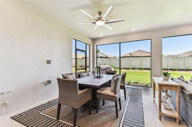 sunroom featuring a ceiling fan