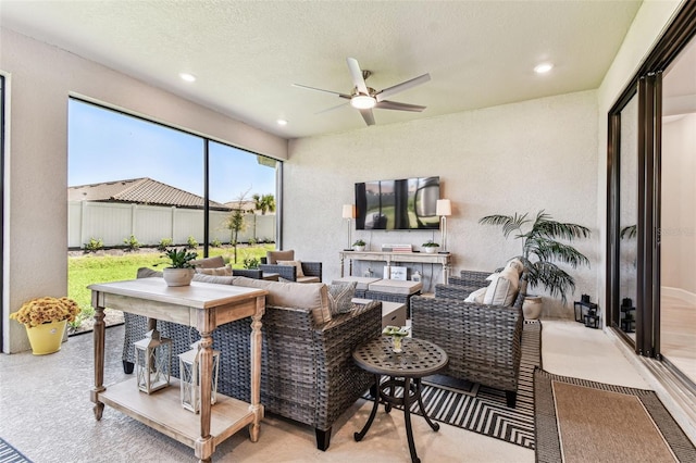 view of patio with an outdoor hangout area, a ceiling fan, and fence