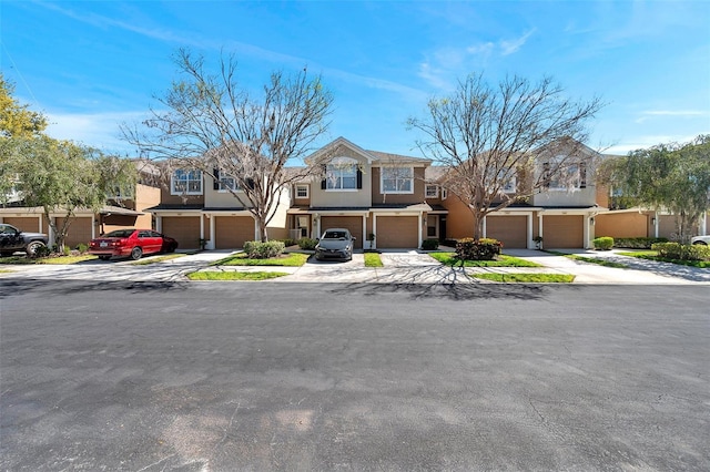 view of property with stucco siding, concrete driveway, and a garage