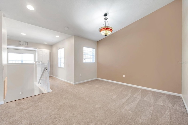 unfurnished room with recessed lighting, baseboards, visible vents, and light carpet