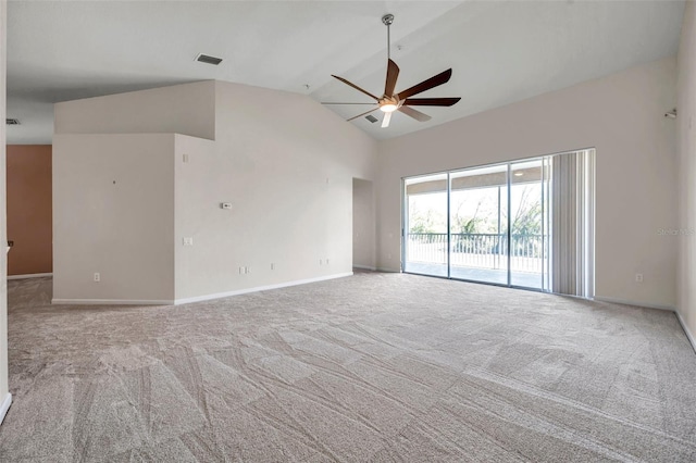 carpeted spare room featuring lofted ceiling, a ceiling fan, visible vents, and baseboards