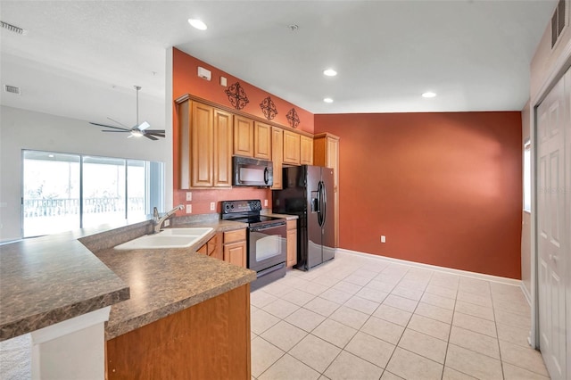 kitchen with black appliances, a sink, recessed lighting, a peninsula, and light tile patterned floors