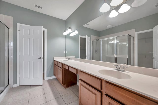 bathroom featuring a sink, visible vents, a shower stall, and tile patterned floors