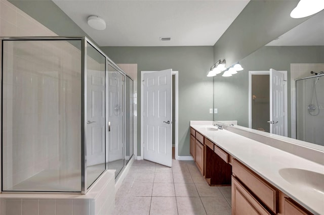 full bathroom featuring tile patterned flooring, a shower stall, double vanity, and a sink