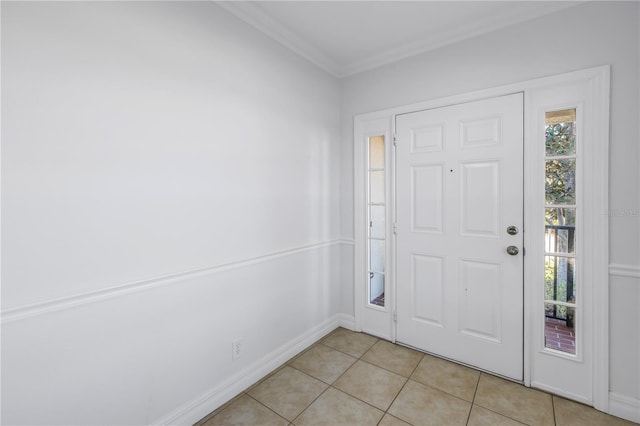 entrance foyer with crown molding, light tile patterned flooring, and baseboards