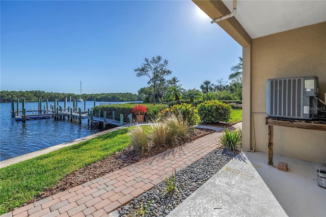 view of patio featuring central air condition unit, a dock, and a water view