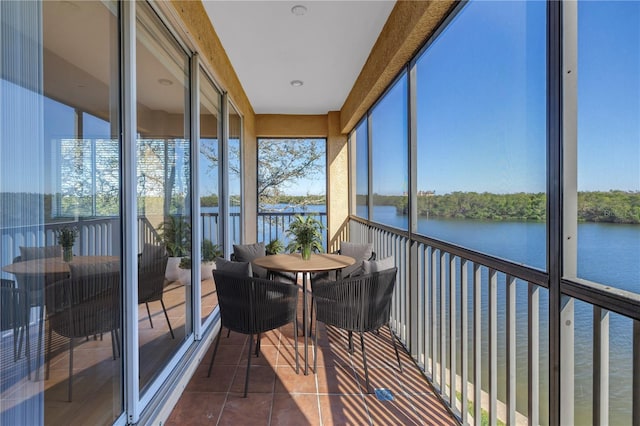 sunroom / solarium with a water view