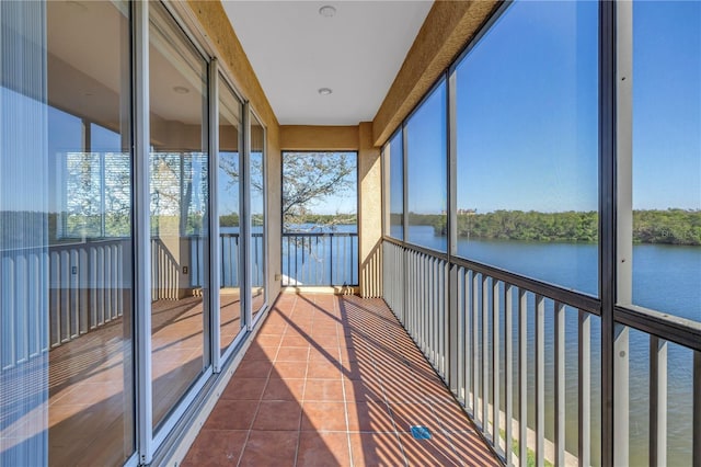 unfurnished sunroom with a water view and a healthy amount of sunlight