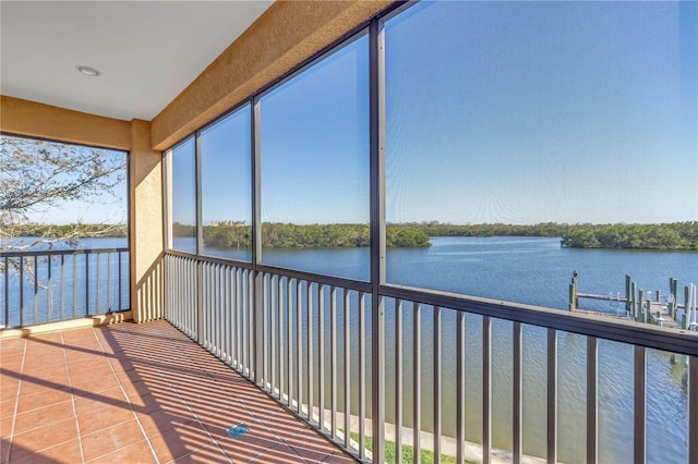 unfurnished sunroom featuring a water view