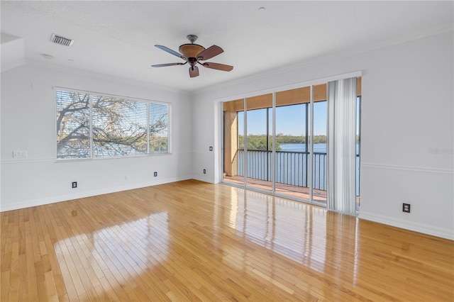 spare room with plenty of natural light, light wood-style flooring, and visible vents