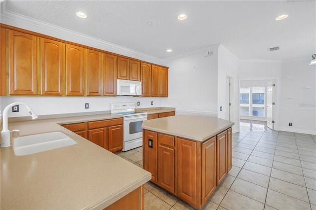 kitchen featuring white appliances, light tile patterned floors, a kitchen island, a sink, and light countertops