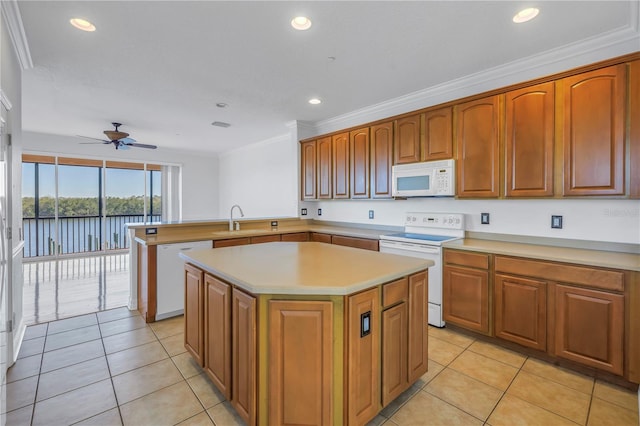 kitchen with white appliances, a ceiling fan, a kitchen island, a sink, and light countertops