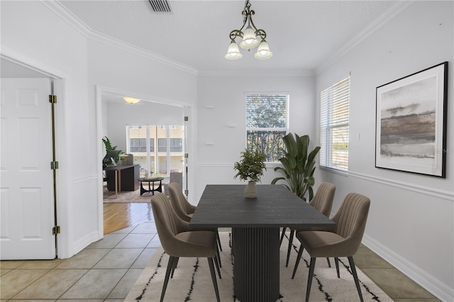 dining area featuring visible vents, plenty of natural light, light tile patterned flooring, and ornamental molding