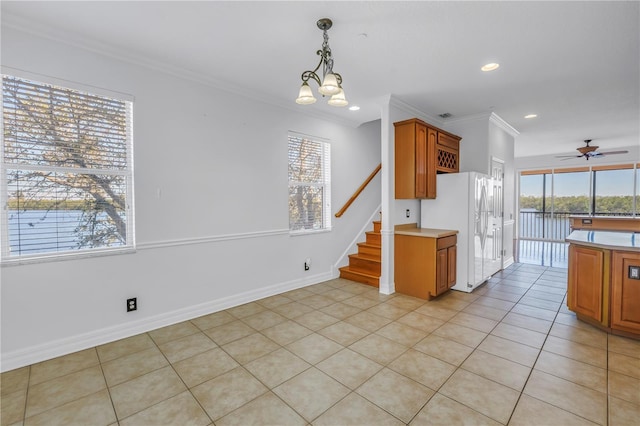 kitchen with plenty of natural light, white fridge with ice dispenser, and light countertops