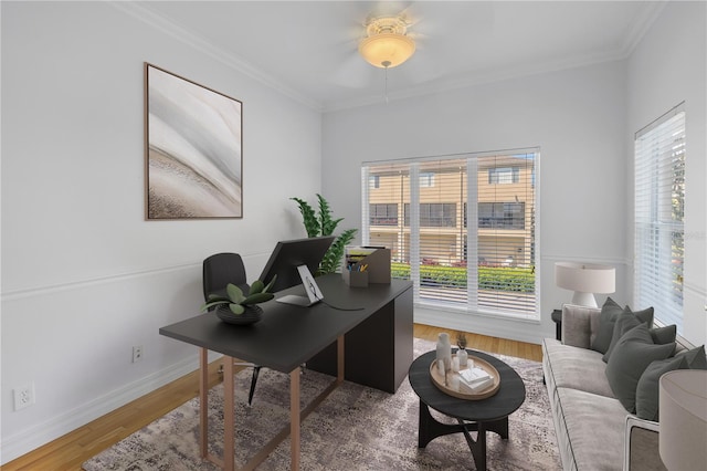 office space featuring wood finished floors, plenty of natural light, ceiling fan, and crown molding