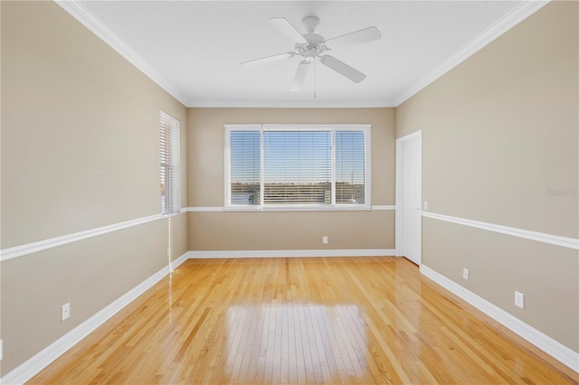 spare room featuring ceiling fan, baseboards, light wood-style floors, and ornamental molding