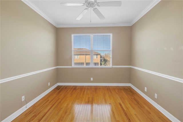 unfurnished room with ceiling fan, baseboards, light wood-type flooring, and ornamental molding