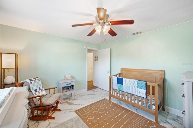 bedroom with visible vents, baseboards, marble finish floor, and ceiling fan