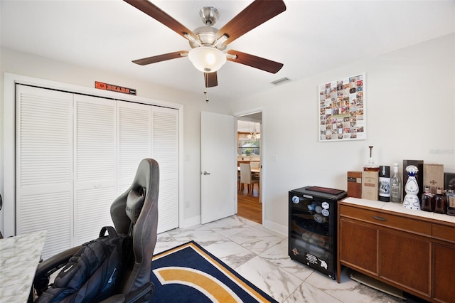 office area with baseboards, visible vents, ceiling fan, wine cooler, and marble finish floor