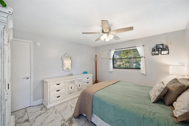 bedroom with marble finish floor and a ceiling fan